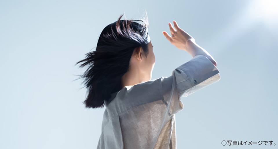 太陽に向かう女性の姿